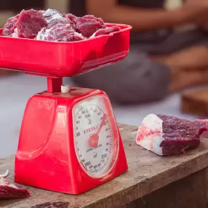 a red scale with meat on top of it - Photo by Zaenal Abidin on Unsplash