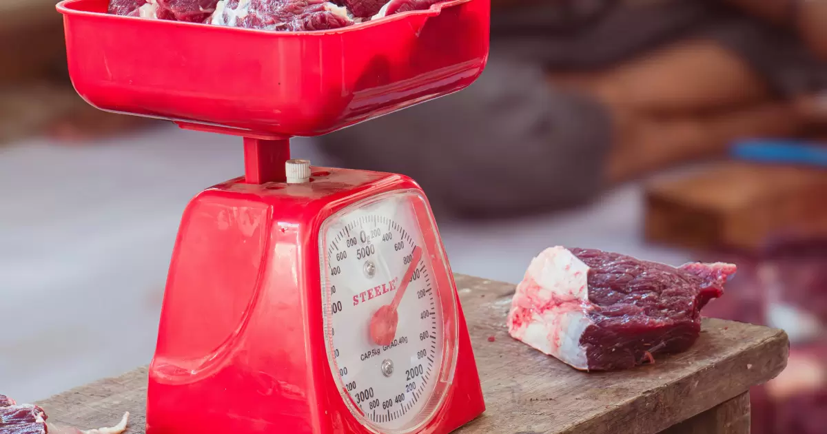 a red scale with meat on top of it - Photo by Zaenal Abidin on Unsplash